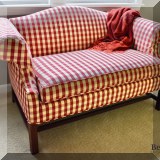 F20. Red check rolled arm loveseat. 32”h x 57”w x 32”d 